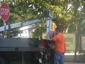 City employees prepare to erect new parking signs outside abortion center