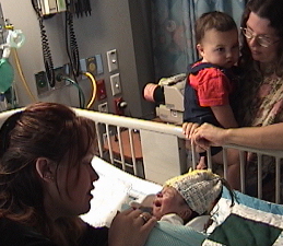 Jessica holds baby Andrew as Terri (holding Jessica's son Matthew) looks on