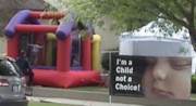 Children jump for joy in bounce house outside LifeHouse