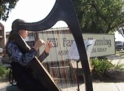 Girl playing harp outside FPA abortion chamber