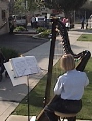 Boy playing harp outside FPA abortion chamber