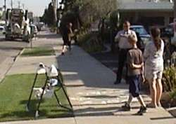 Officer Terry Buss takes a picture of an 'illegal' baby swing outside Bakersfield's abortion chamber